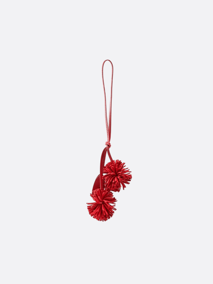 Bijou de sac pompon cuir rouge
